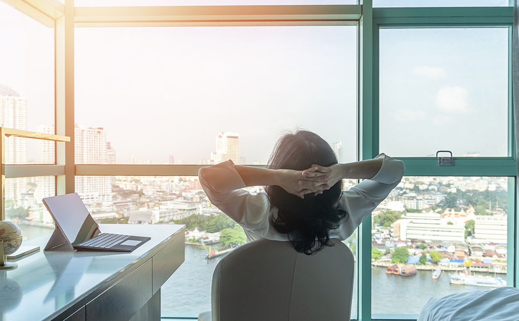 Work-life balance relaxation with Asian working business woman healthy lifestyle take it easy resting in comfort city hotel or home living room having good time with peace of mind, self-satisfaction