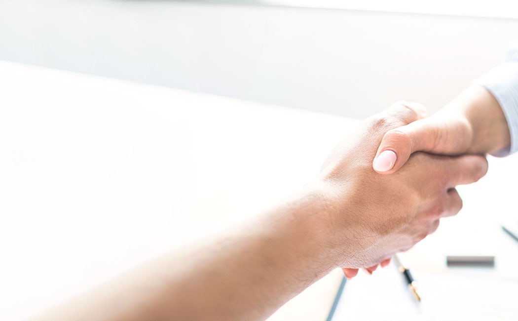 Business people shaking hands, finishing up meeting. Successful businessmen handshaking after good deal.