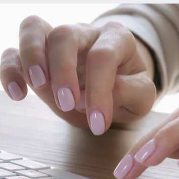 Woman's hands with pink nail polish, typing at a Mac keyboard, employee IT device management, Apple | DXC Technology Insights