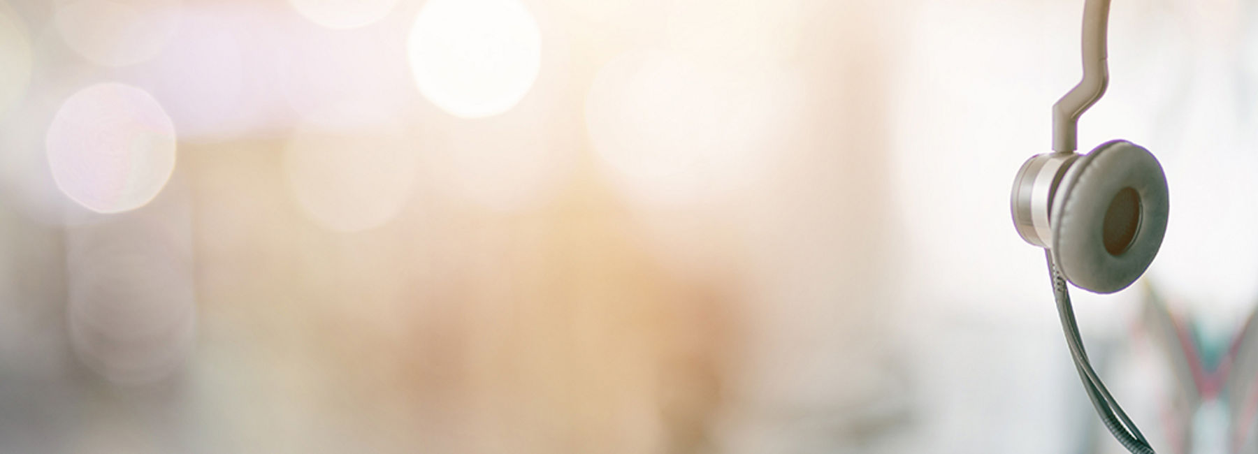 headphones perched atop computer monitor, Modern Workplace | DXC Technology