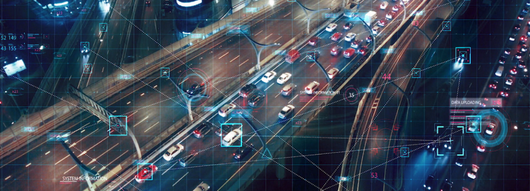 Aerial view of connected cars on city highway at night, Automotive | DXC Technology