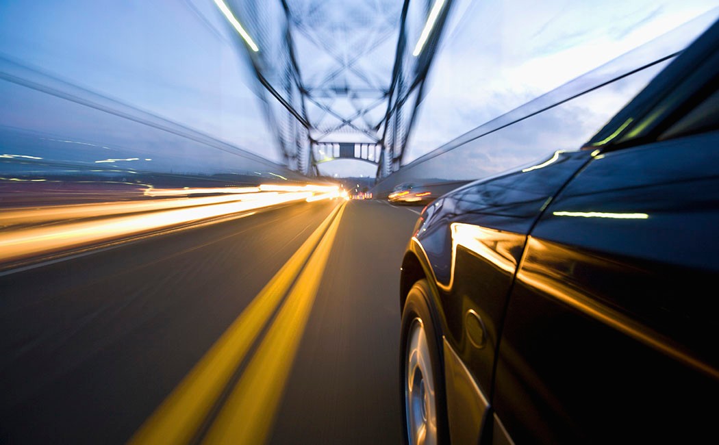 Car Speeding along Busy Bridge, Business process services: Property and casualty | DXC Technology