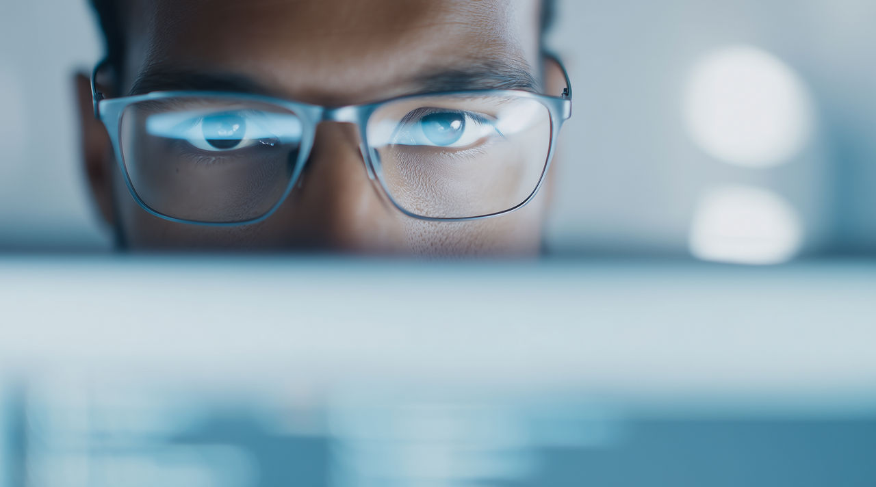 Hands holding a glowing digital globe, symbolizing global AI and cybersecurity impact | DXC Technology Insights