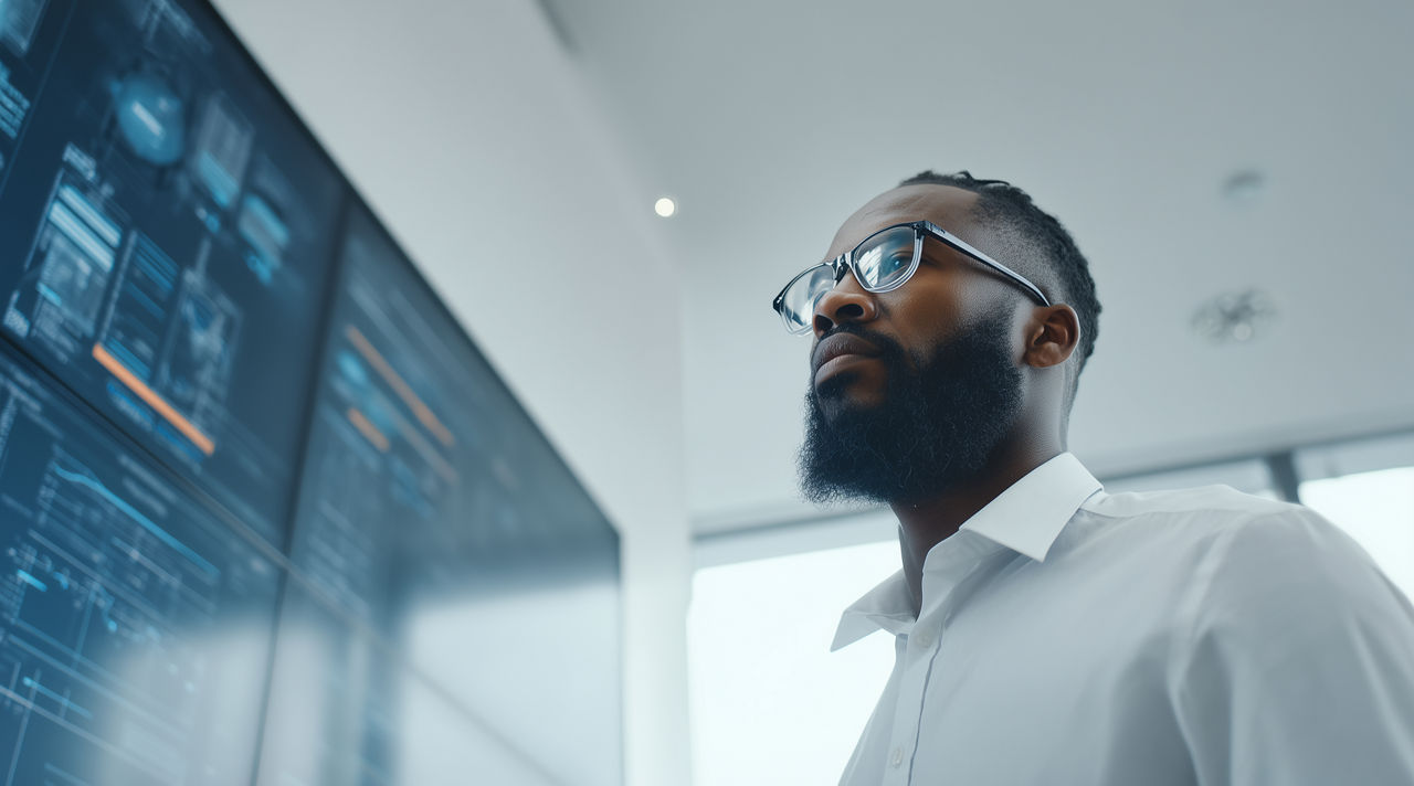African-American data engineer inspecting GenAI code on a screen, AI Workbench | DXC Technology