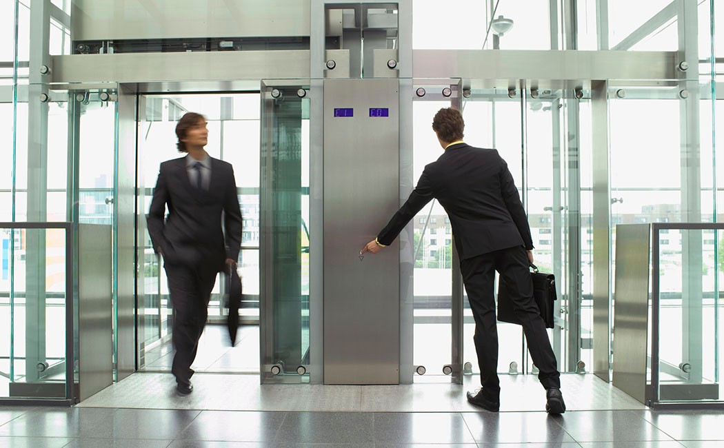 Businessmen arriving and leaving on elevators --- Image by © Juice Images/Corbis