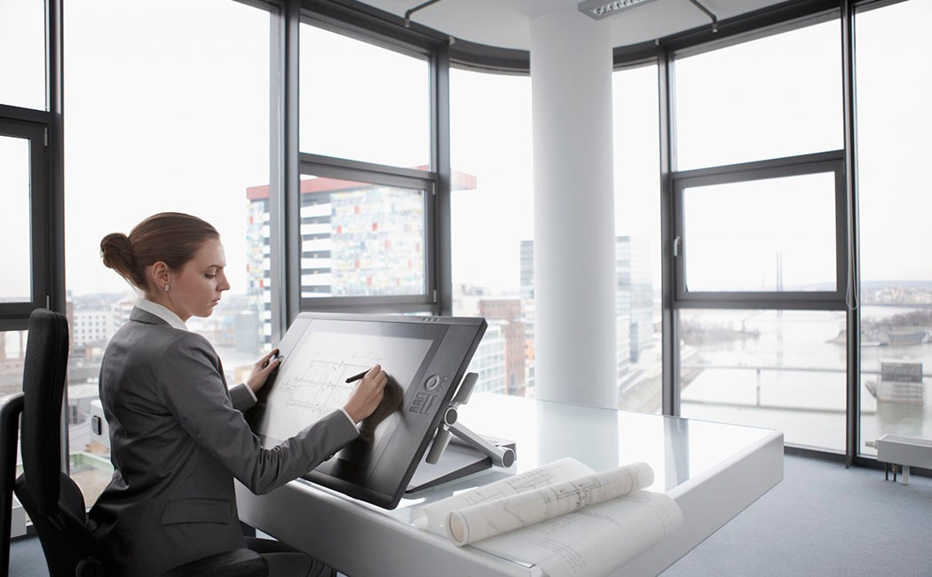 Architect working on digital tablet --- Image by © John Smith/Corbis