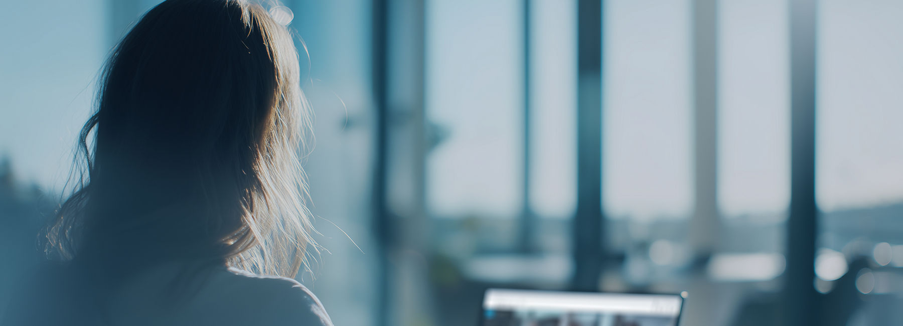 Female employee in online meeting on laptop with multiple, Intelligent Collaboration | DXC Technology