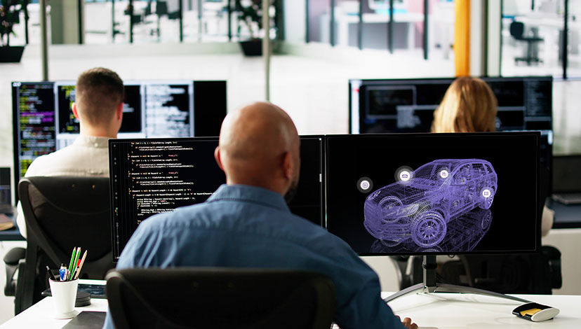 Automotive engineers working at screens - The need for testing in a vehicle-to-everything world | DXC Technology Insights