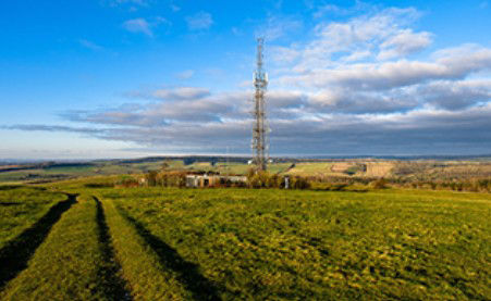 telecom tower in a field, Oracle | DXC Technology Customer Story