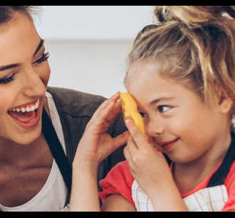 Woman holding child laughing