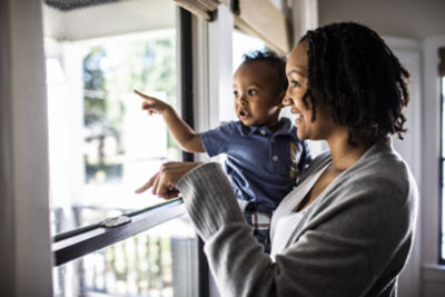 mother and toddler looking out of window