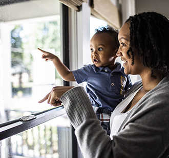 mother and toddler looking out of window