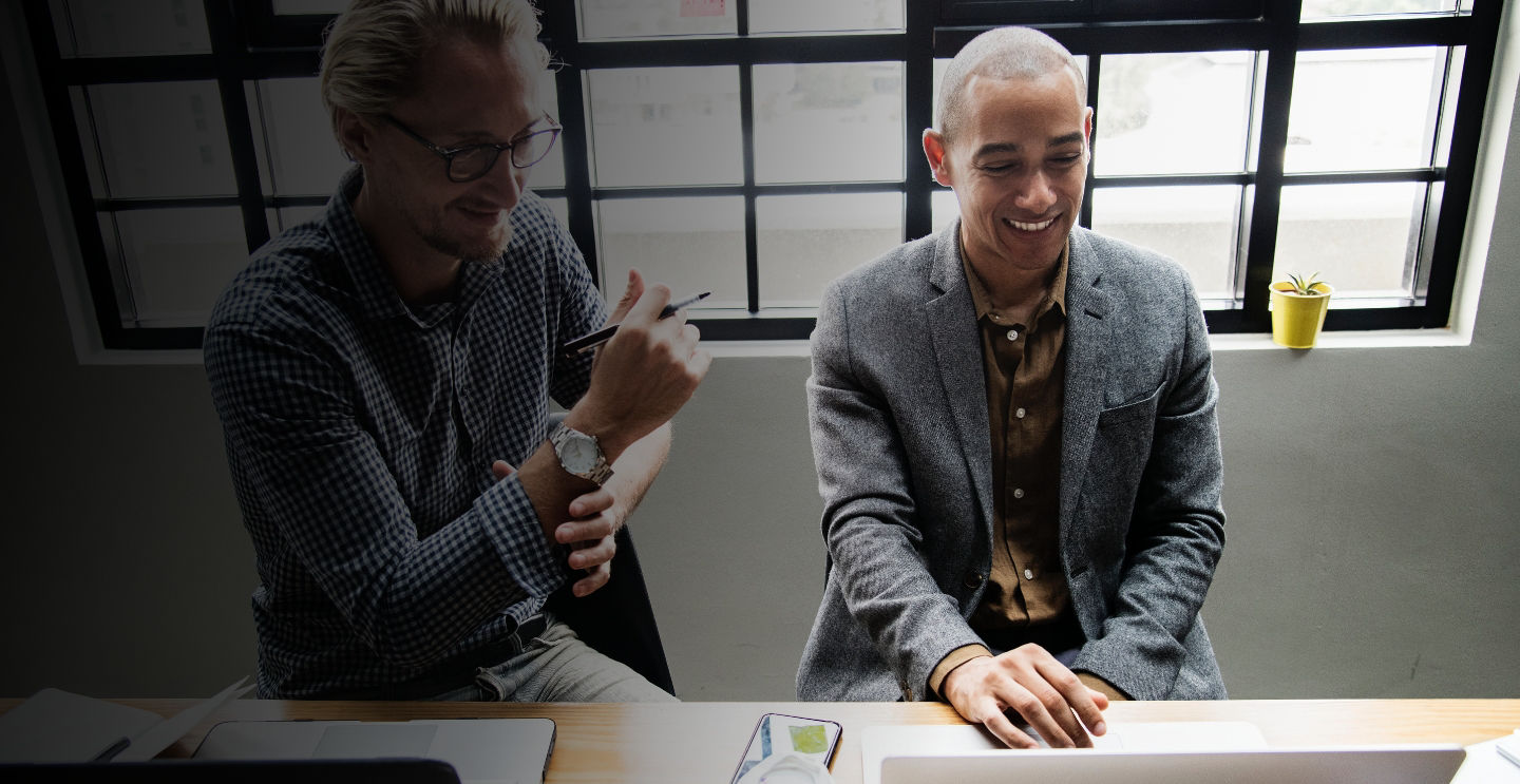 two men looking at computer