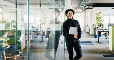 man in mid-sized business office