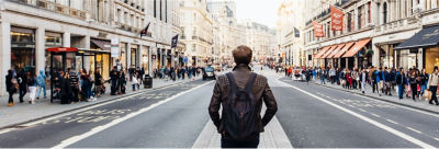 Man looking down city street