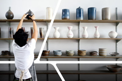 Merchant stocking pottery on a shelf.