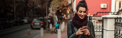 woman walking and texting