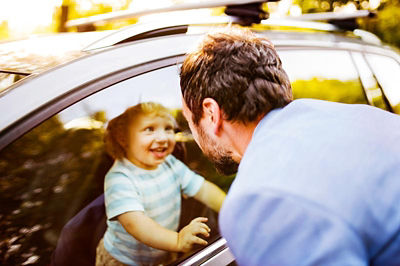 Boy in car looking at his Dad