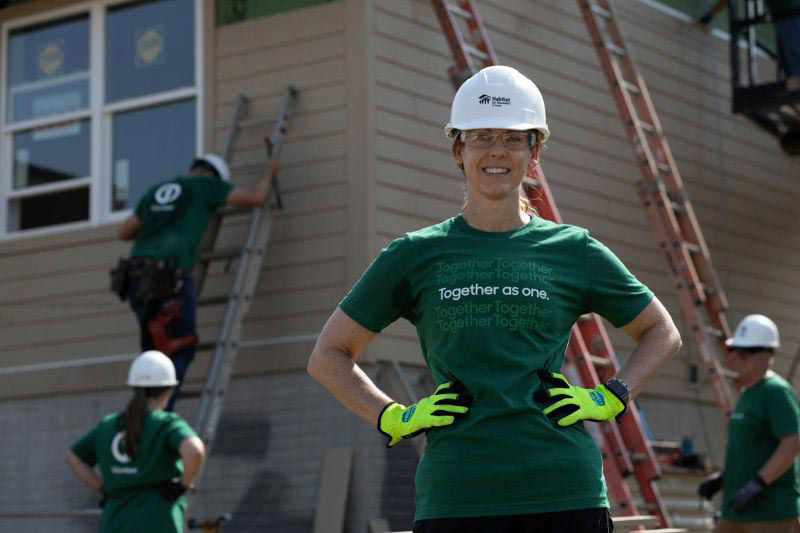 Employee volunteering at a Habitat for Humanity work site.