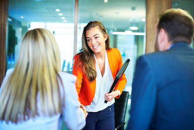 Young female job applicant shaking prospective employers hands