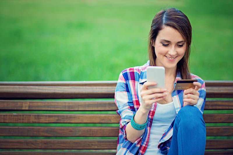 Woman on her smart phone buying something.