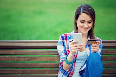Woman on her smart phone buying something.