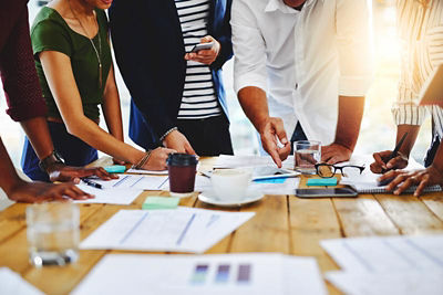 Group of co-workers reviewing paperwork