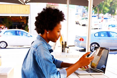 Woman doing her online banking at the coffee shop