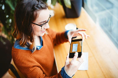 Woman doing a Remote Deposit with Cell Phone