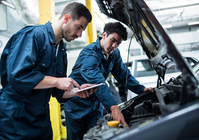 Mechanics working on car
