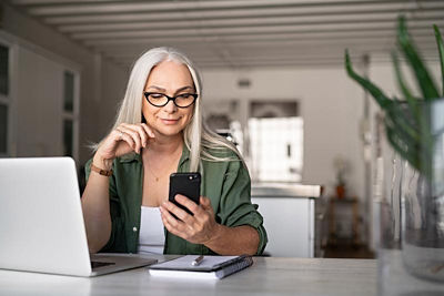 Woman on her laptop and smart phone