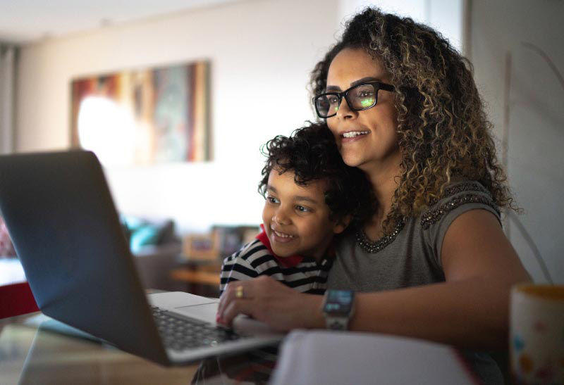 Mom and son on laptop - physician's mortgage