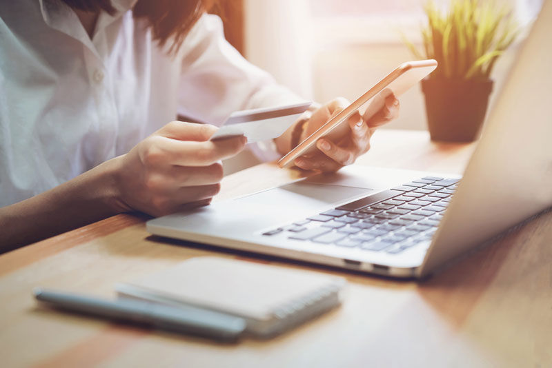 Woman buying something online with her credit card.