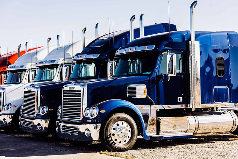 Group of tractor trailers in a parking lot