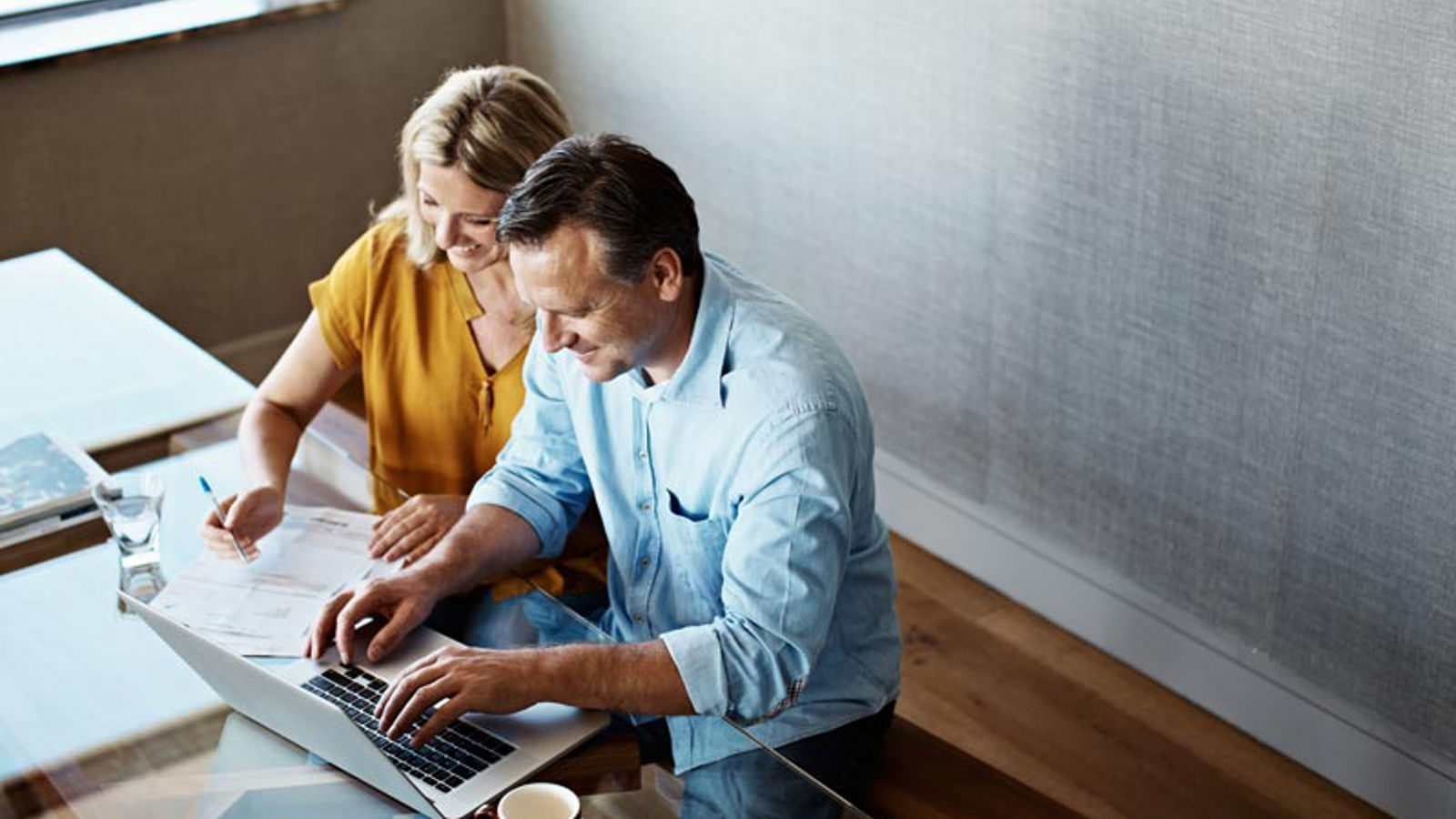 A couple doing their online banking on their laptop