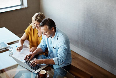 A couple doing their online banking on their laptop