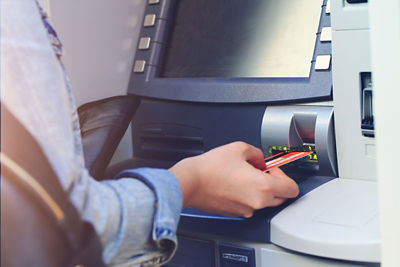 Woman's hand using an ATM