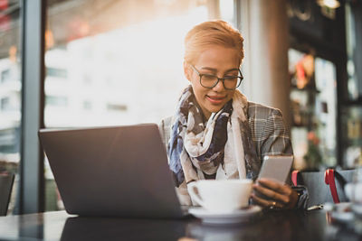 Woman on phone and laptop - 25k Money Market