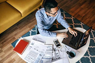 Business man in living room on laptop