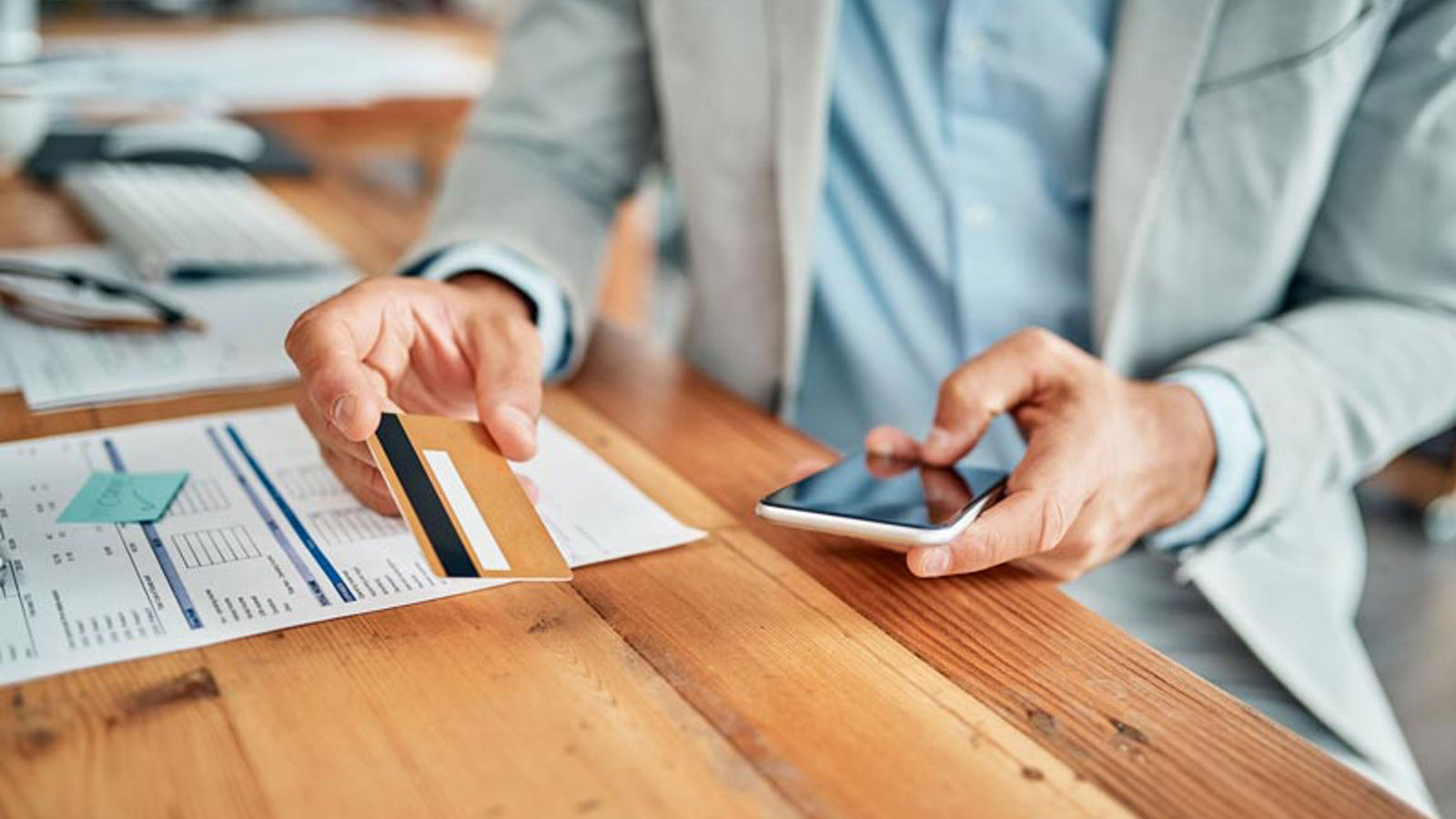 Man buying something on his smartphone with his credit card
