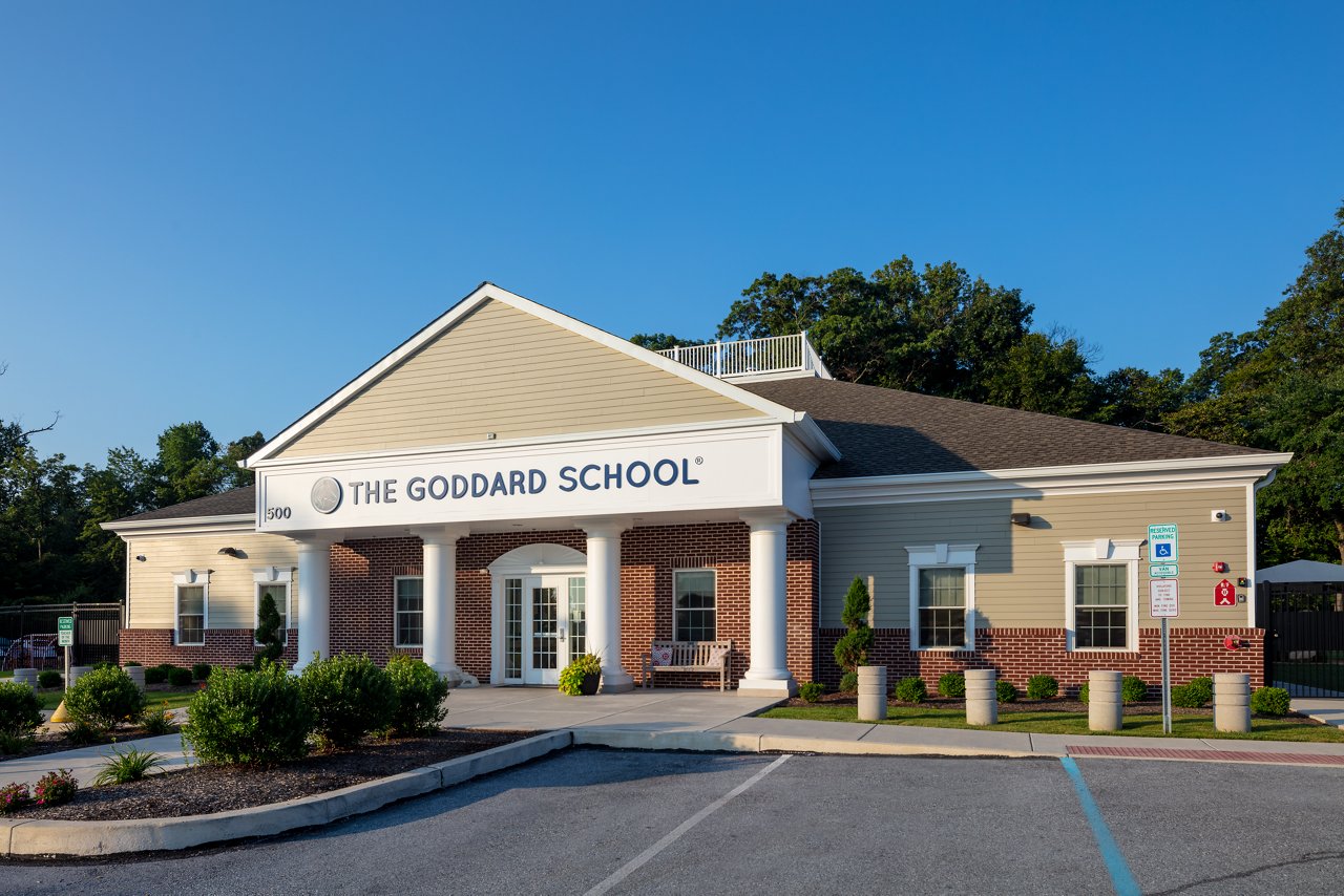 Exterior photo of a Goddard School with a bright blue sky