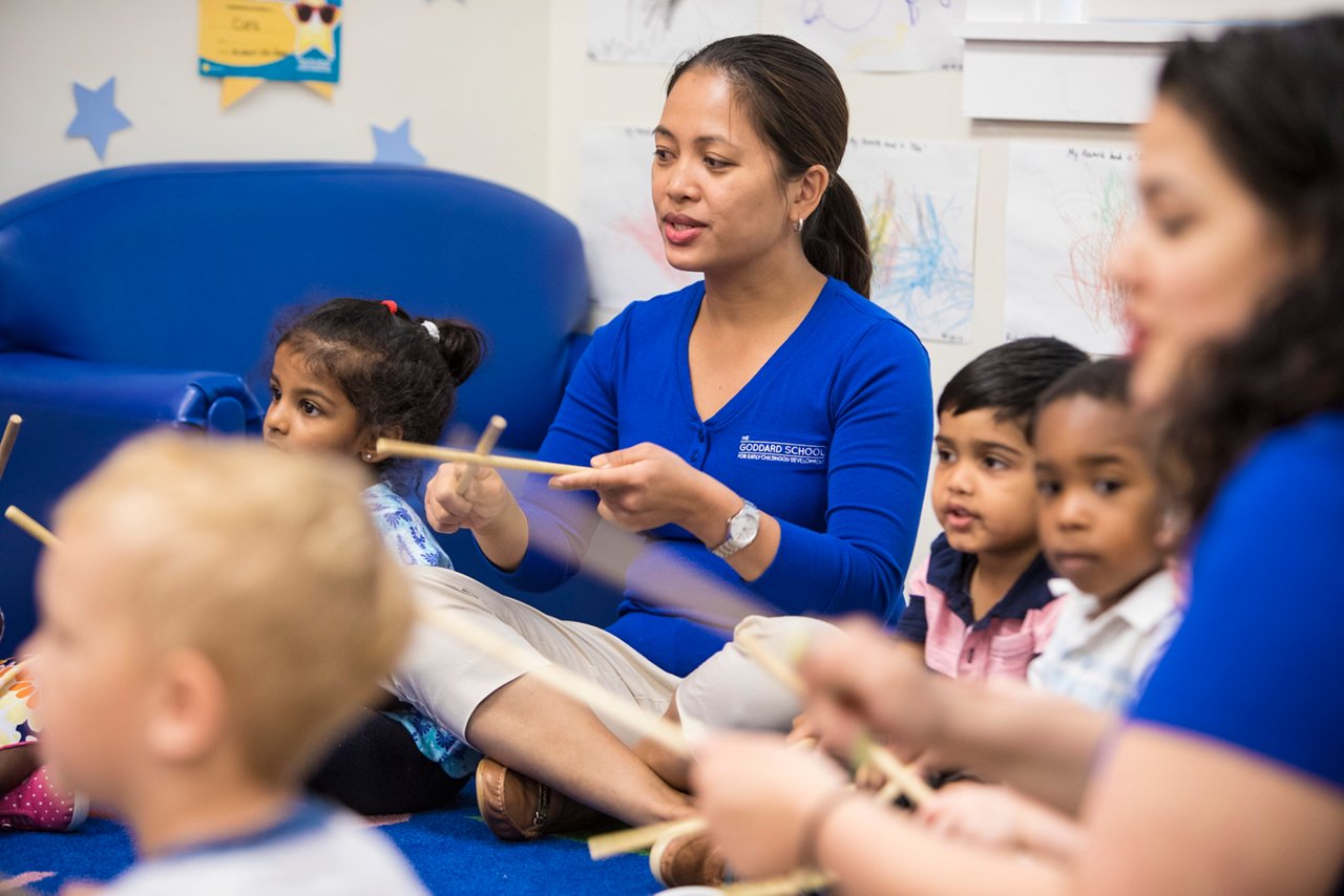 teacher playing with two preschoolers