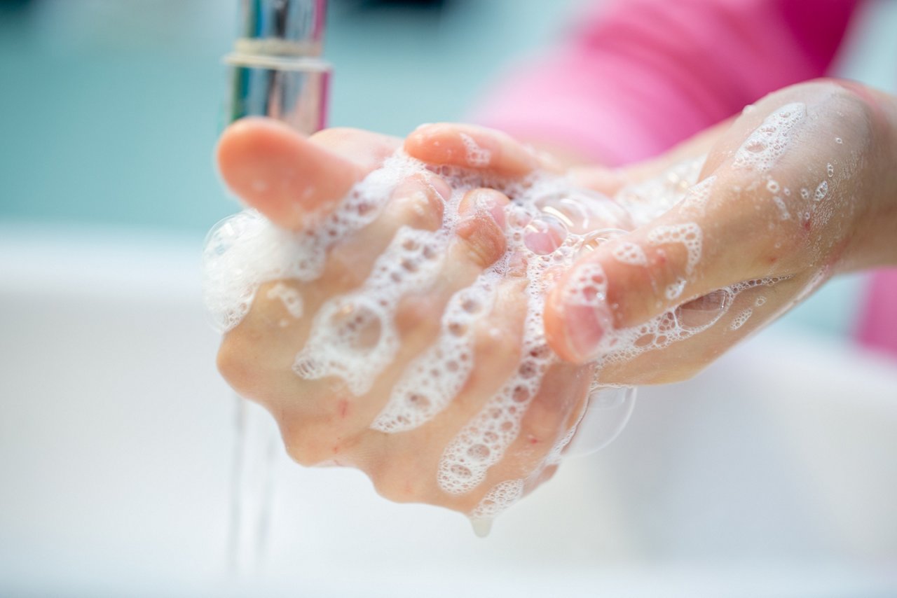 Little Girl washing hands with antibacterial soap