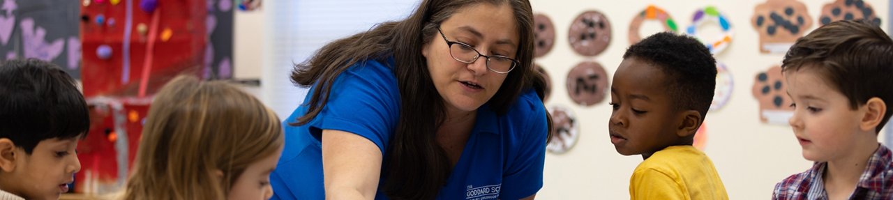 teacher with students working on a project