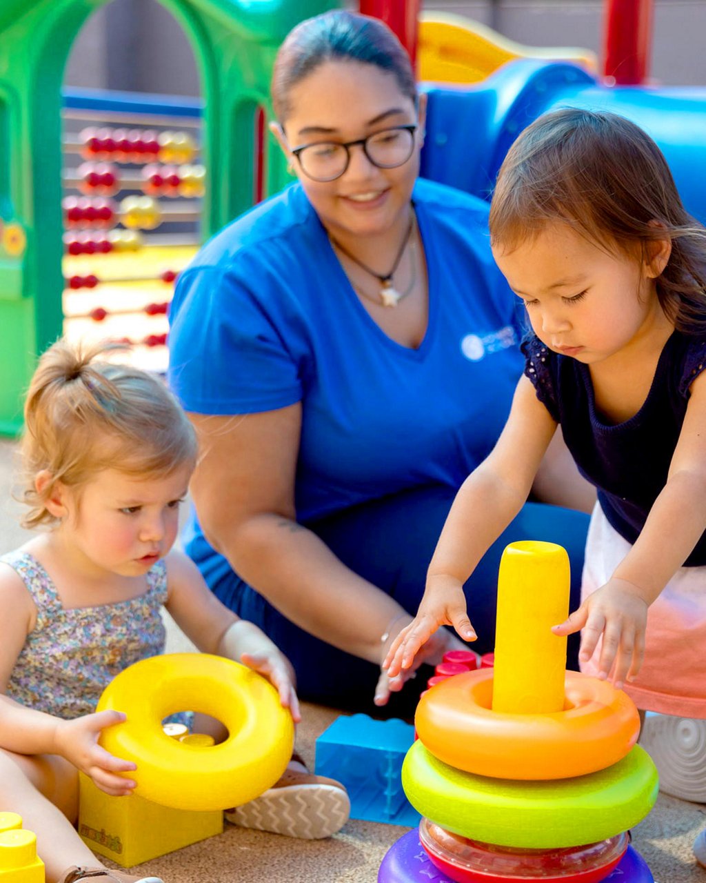 Children solving a puzzle with their teacher