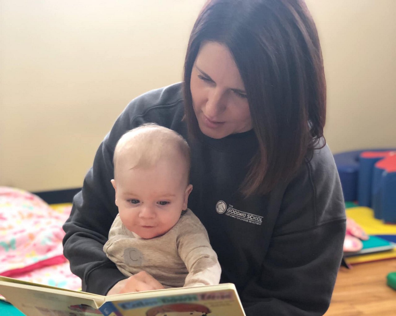 Teacher reading to infant