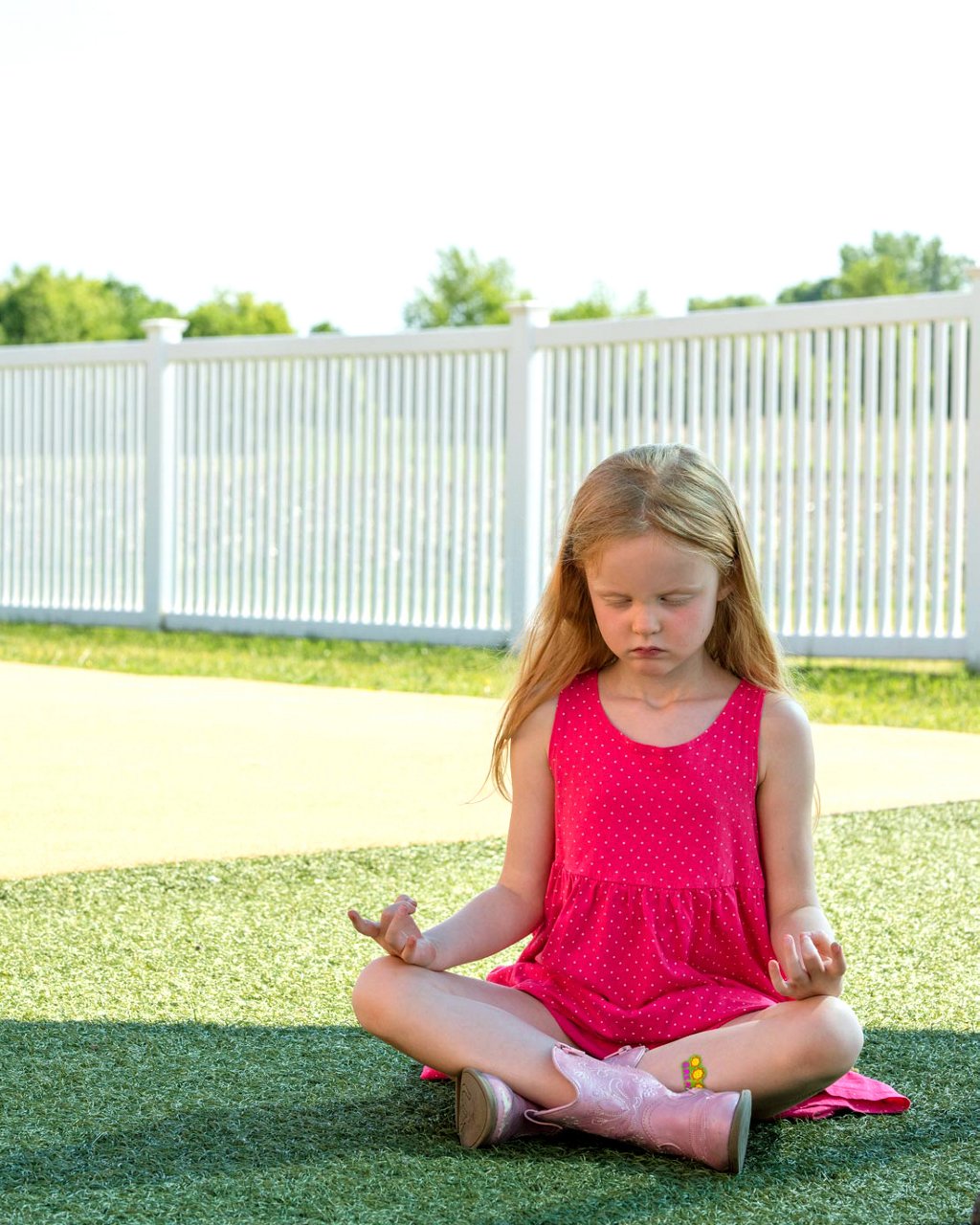 A child meditating outdoors 