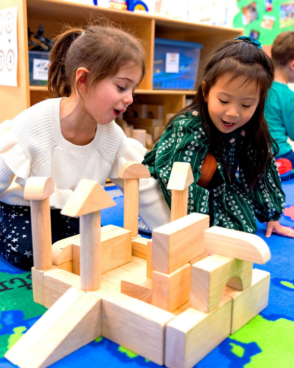 Two children building with wooden blocks 