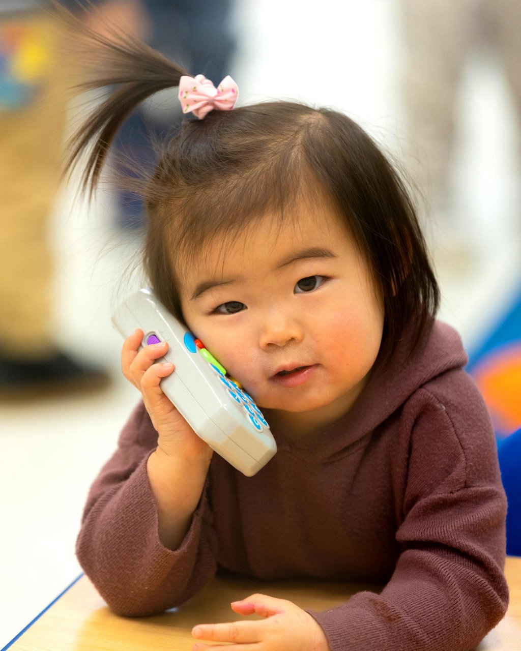 A child playing with a play phone 