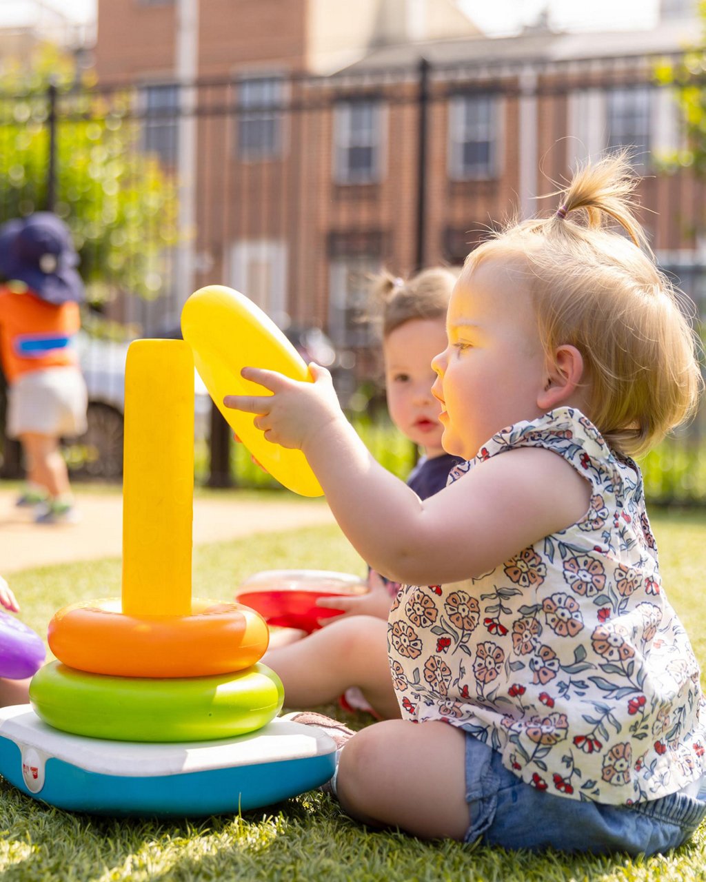 A child placing rings on a toy 